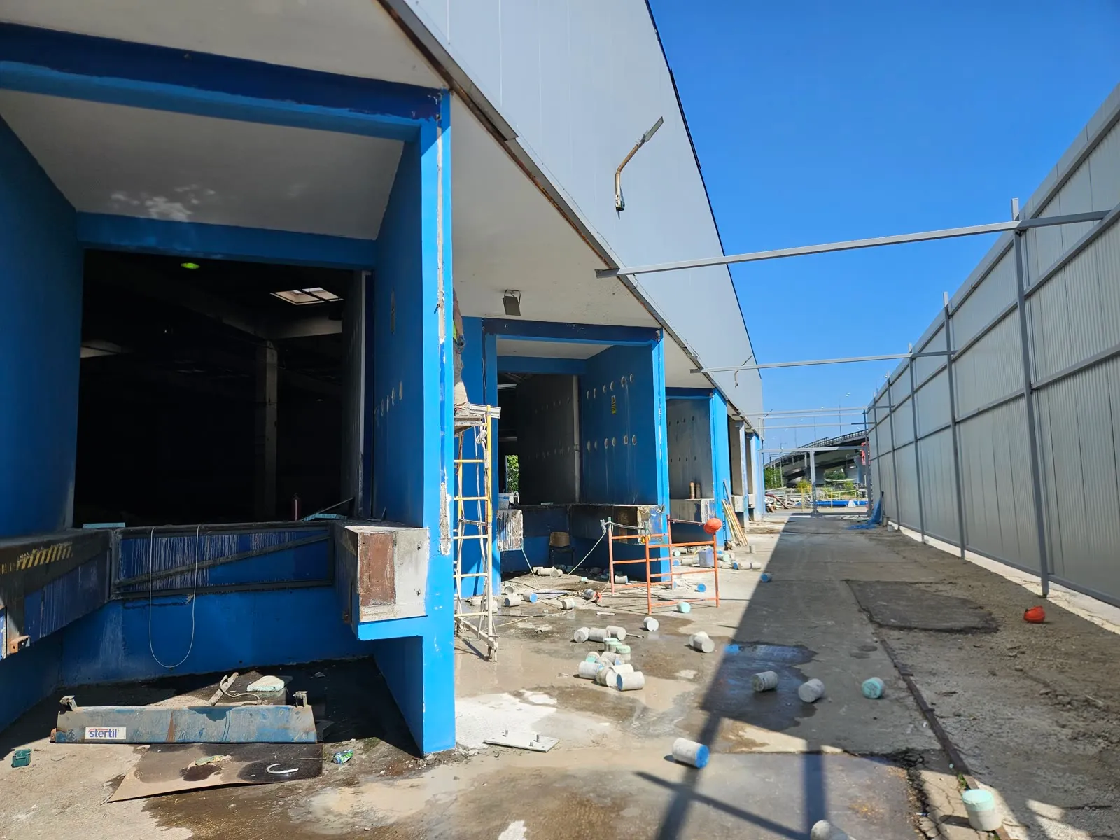 Extracted concrete cores on the ground during selective demolition of loading dock structures