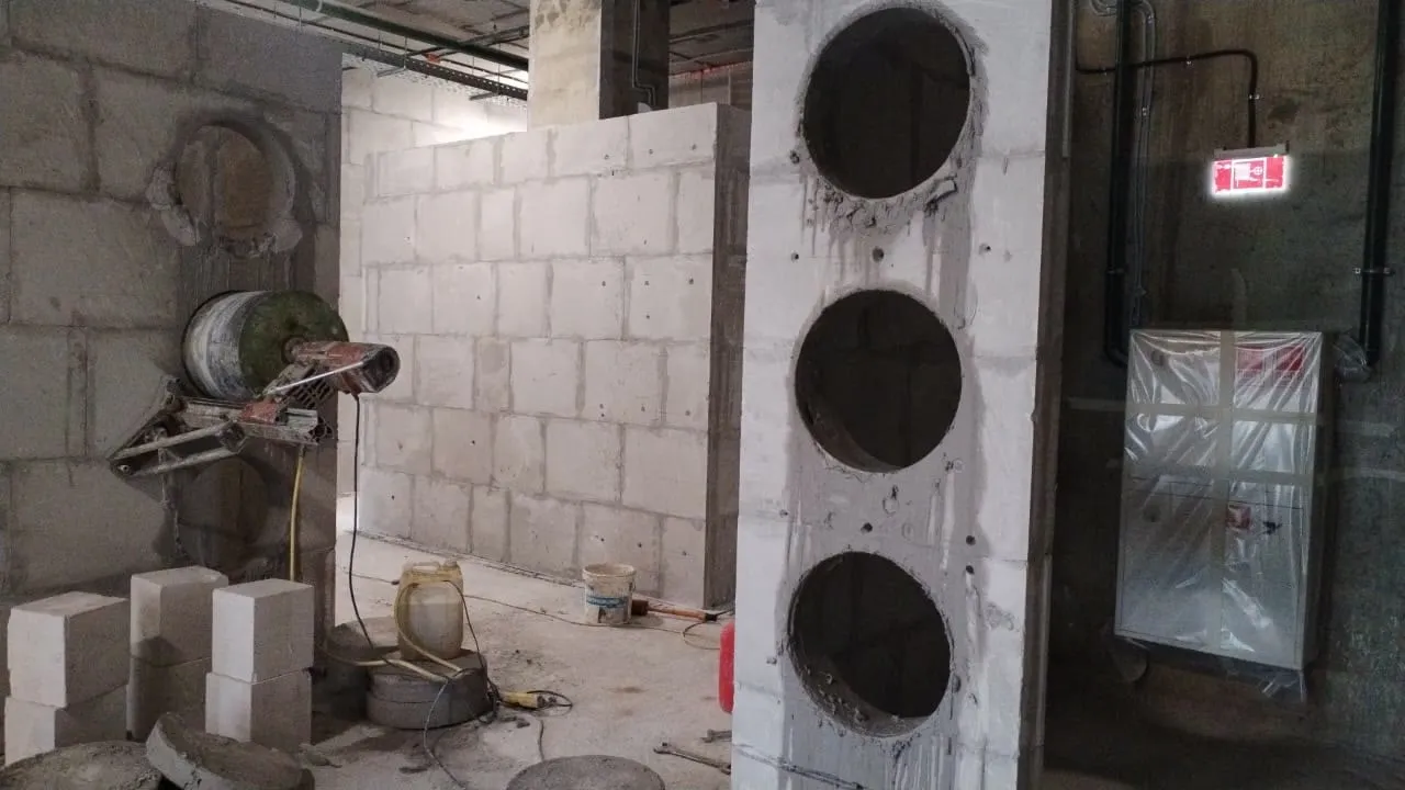 High-frequency wall saw drive unit on its track mid-cut