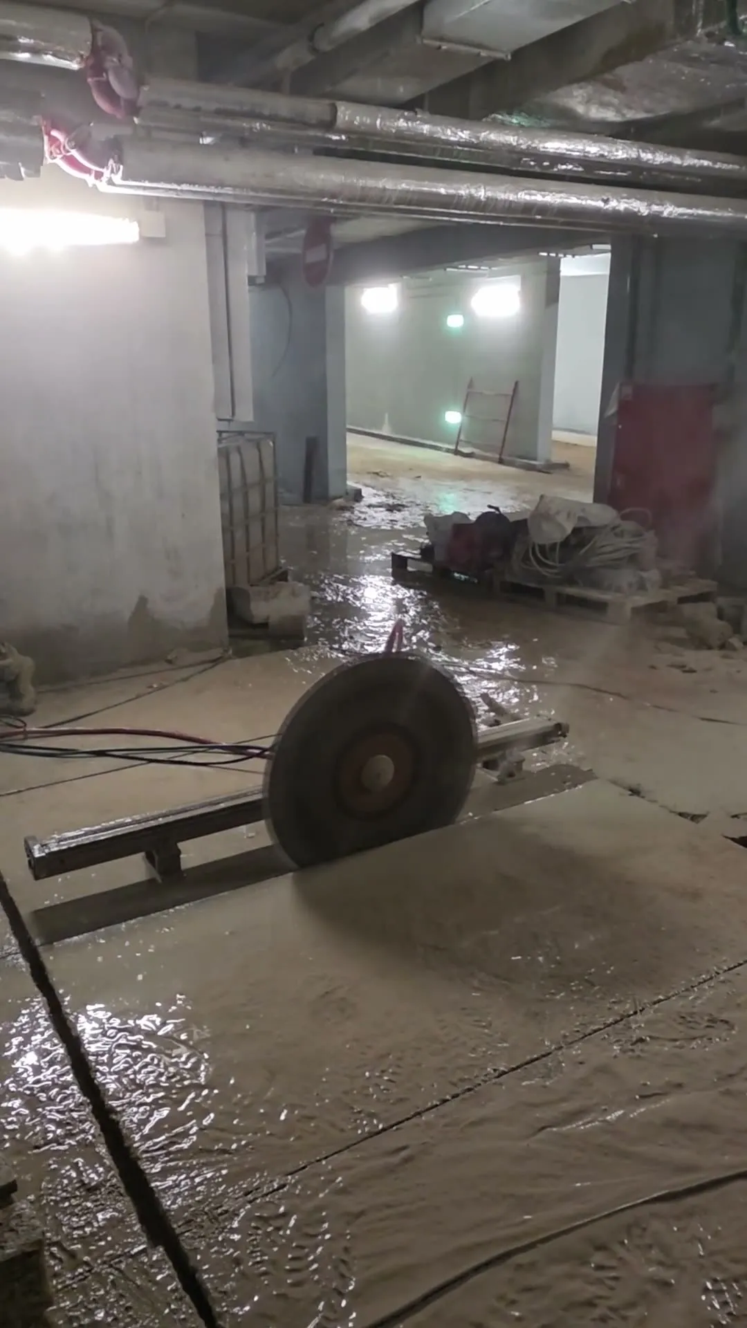 Diamond wire saw flywheel spinning in a parking structure — video still